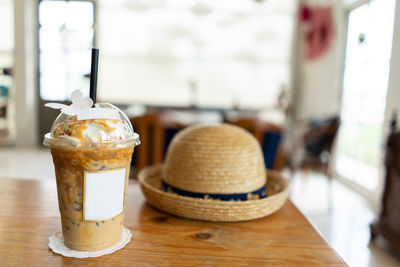 Ice coffee and whipped cream with caramel sauce on table