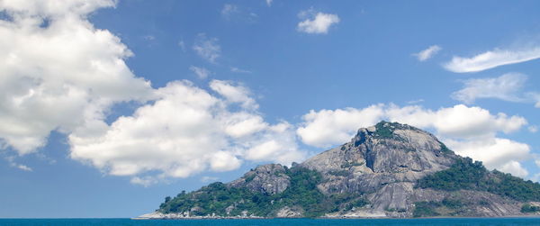 Scenic view of sea and mountains against sky