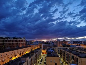 High angle view of illuminated buildings against sky at sunset