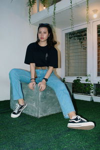 Portrait of young woman sitting outdoors