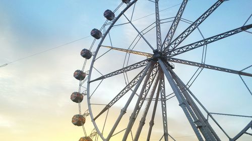 Low angle view of ferris wheel against blue sky