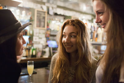 Portrait of a smiling young woman in restaurant