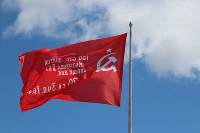 Low angle view of flag against sky