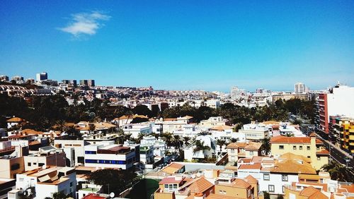 High angle view of townscape against blue sky