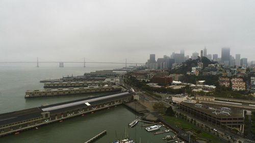 High angle view of bridge over river in city against sky