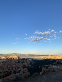 Scenic view of landscape against blue sky