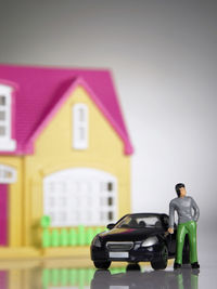 Close-up of toy car against toy house