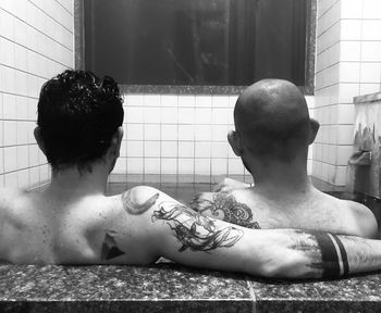 Rear view of shirtless men in a jacuzzi 