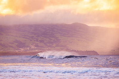 Waves in the atlantic ocean, before sunset, colorful sky, azores travel destination.