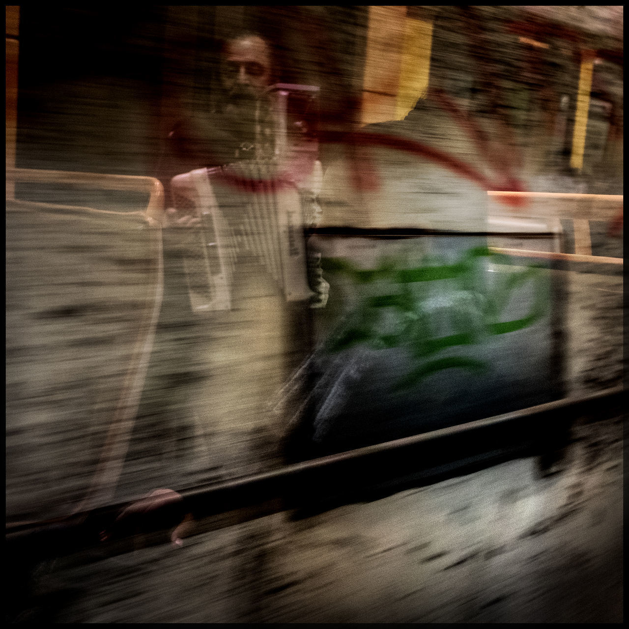 BLURRED MOTION OF MAN STANDING ON TRAIN