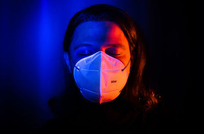 Illuminated man wearing medical protective face mask