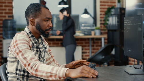 Close-up of computer programmer working at office