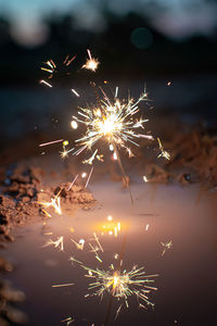 Close-up of sparkler in water outdoors