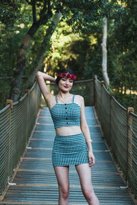 Full length of woman standing on footbridge