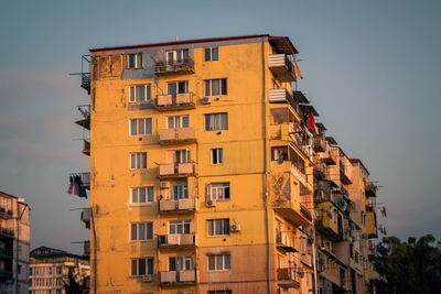 Low angle view of buildings against sky during sunset