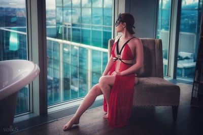 Woman looking through window