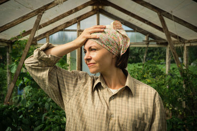 Woman looking away in greenhouse