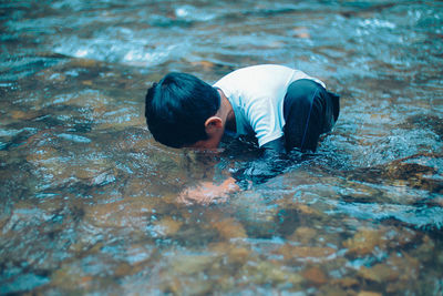 High angle view of boy swimming in pool