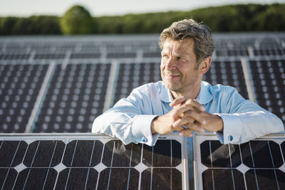 Mature man standing in solar plant