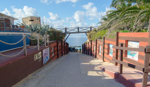 View of swimming pool by sea against sky