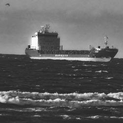 Ship sailing on sea against sky