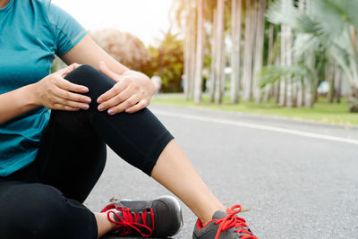 Fitness woman runner feel pain on knee. outdoor exercise activit