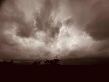 Silhouette landscape against dramatic sky