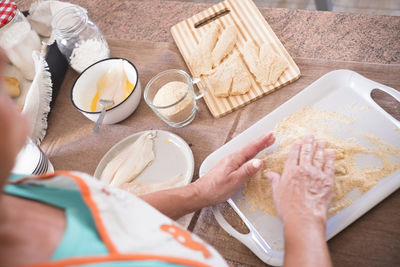 High angle view of woman preparing food on table