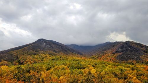 Scenic view of mountains against cloudy sky