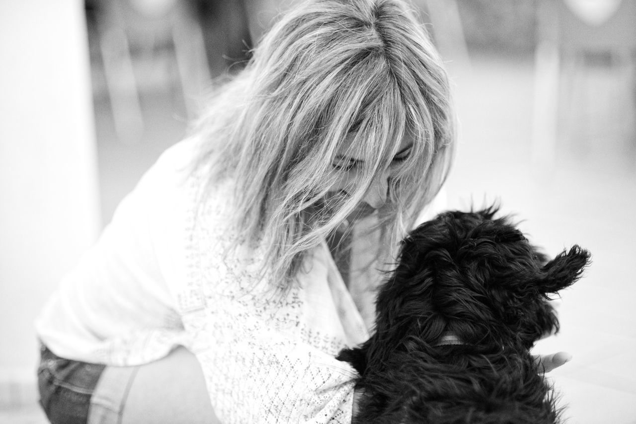 REAR VIEW OF WOMAN WITH DOG AGAINST SKY