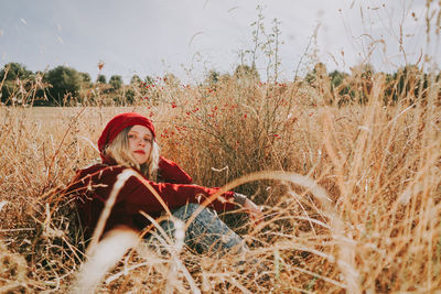 Portrait of young woman on field