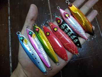 High angle view of hand holding multi colored candies