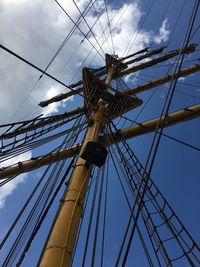 Low angle view of mast against cloudy sky