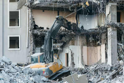 Photo of building demolition excavator, destruction of a building, house ruins, reconstruction