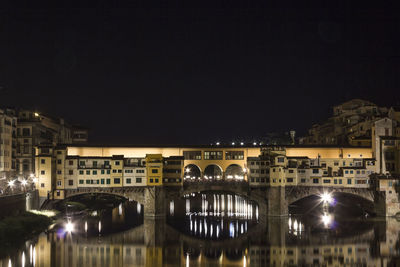 Illuminated buildings against clear sky at night