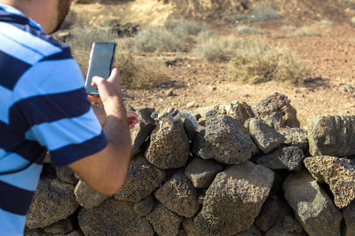 Midsection of man using mobile phone