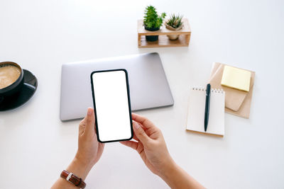 Cropped image of woman holding mobile phone