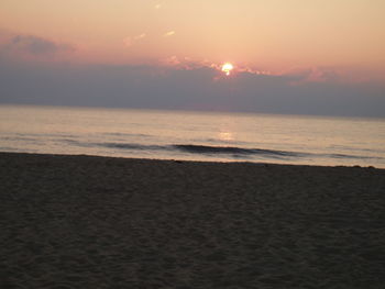 Scenic view of beach against sky during sunset