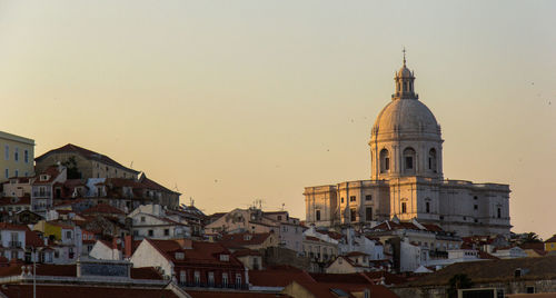 Low angle view of buildings in city against clear sky