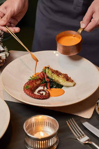Midsection of man preparing food on table