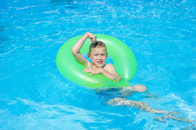 Portrait of a boy swimming in pool