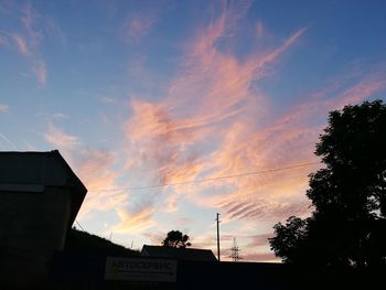 Low angle view of silhouette building against sky during sunset