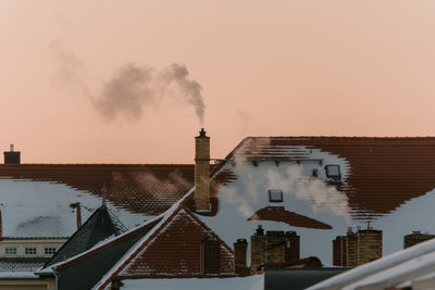 Smoke emitting from chimney against sky