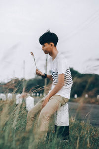 Side view of boy standing on field