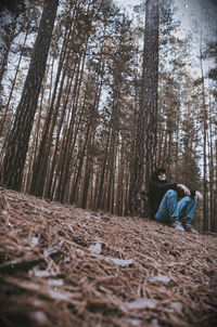 Man amidst trees in forest