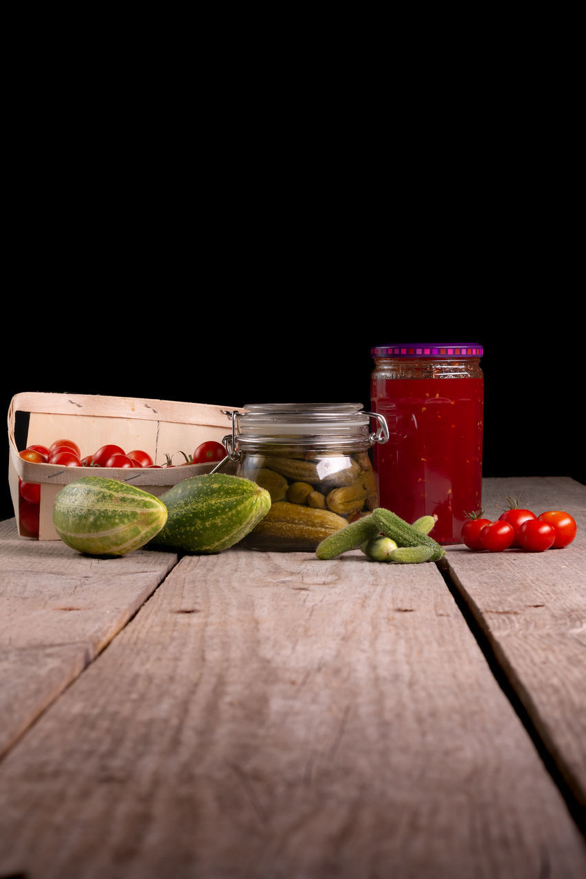 VARIOUS FRUITS ON TABLE AGAINST GLASS