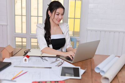 Young woman using laptop on table