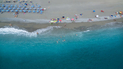 High angle view of people enjoying at beach