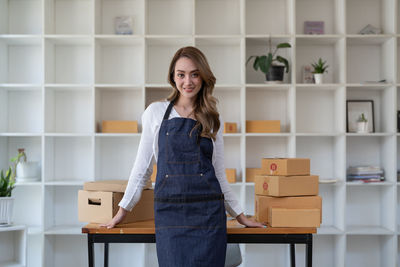 Portrait of young woman standing in library
