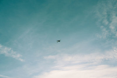 Low angle view of airplane flying in sky